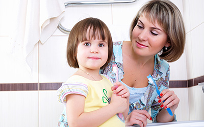 Mother and daughter about to brush teeth