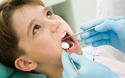 Young boy in dental chair having exam