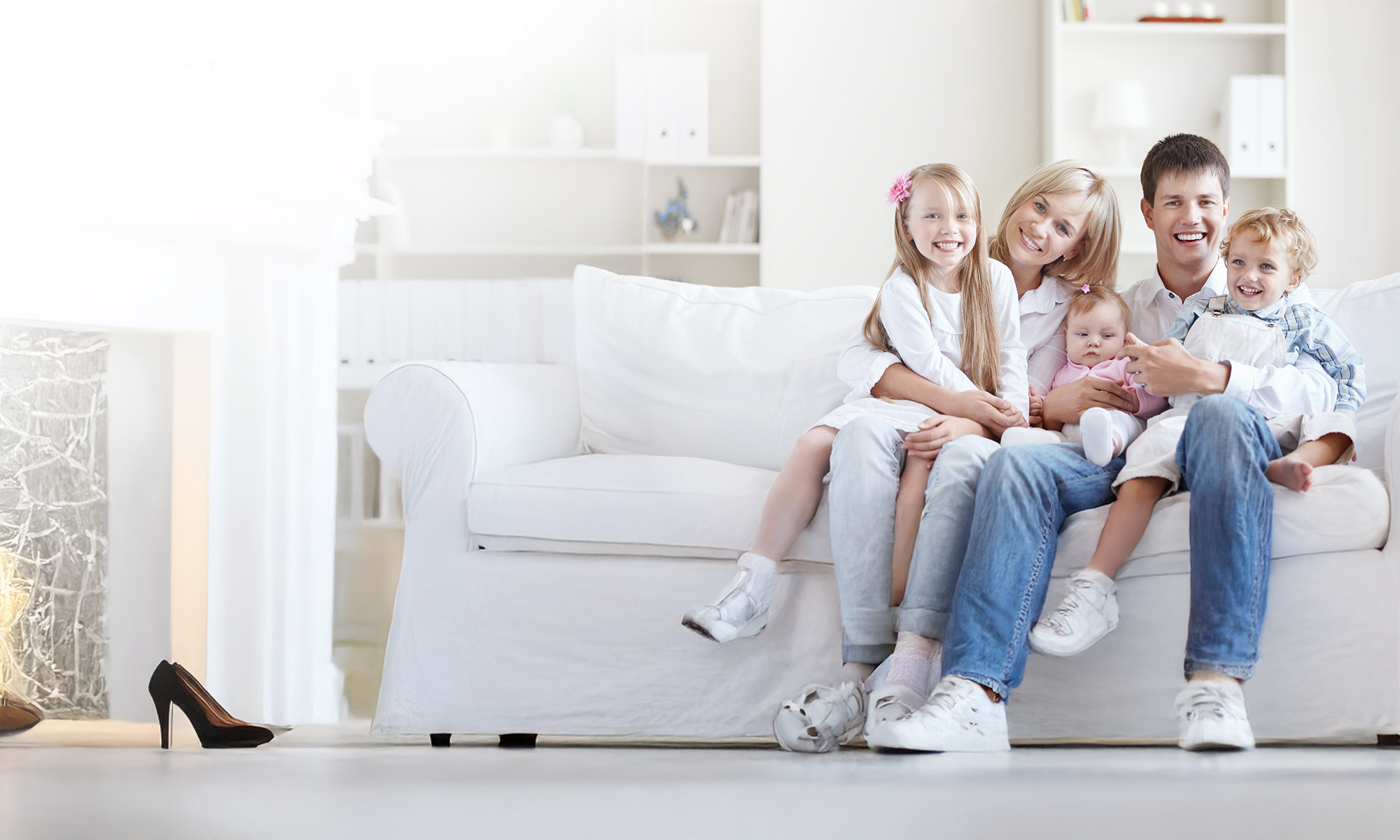 Family sitting and smiling on a couch