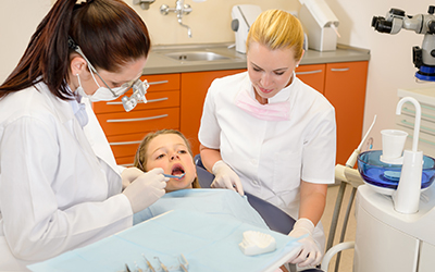 Young girl having teeth cleaned