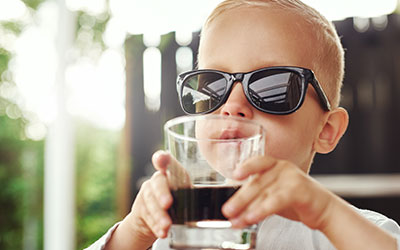 Cute kids with glass of soda