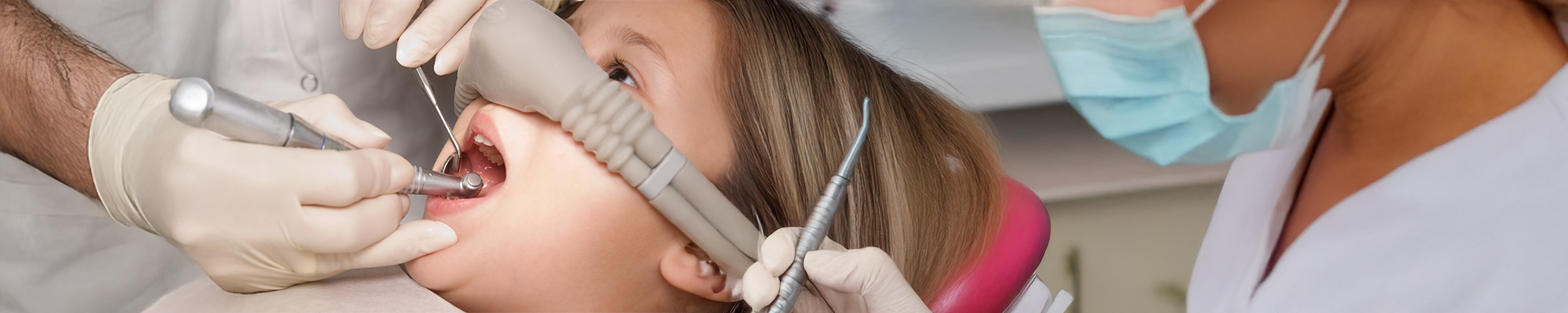 A child in a dental chair receiving sedation