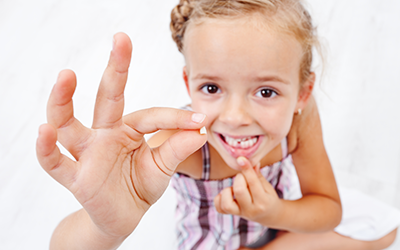 Child with tooth in hand
