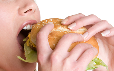 Woman biting into burger