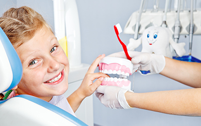 A young girl sitting in a dental chair